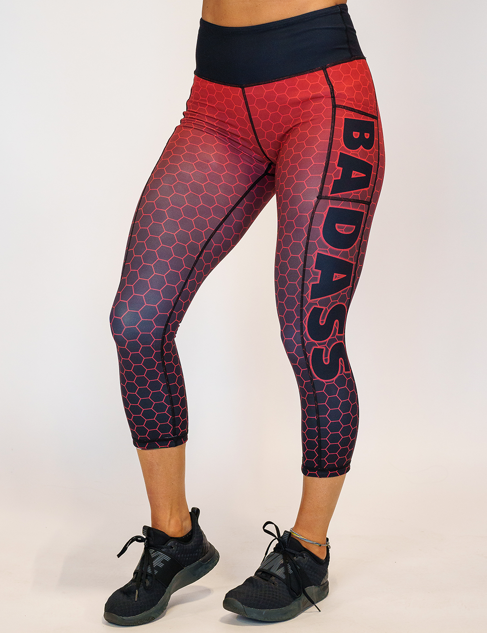 model wearing the capri red hex badass leggings against a white background