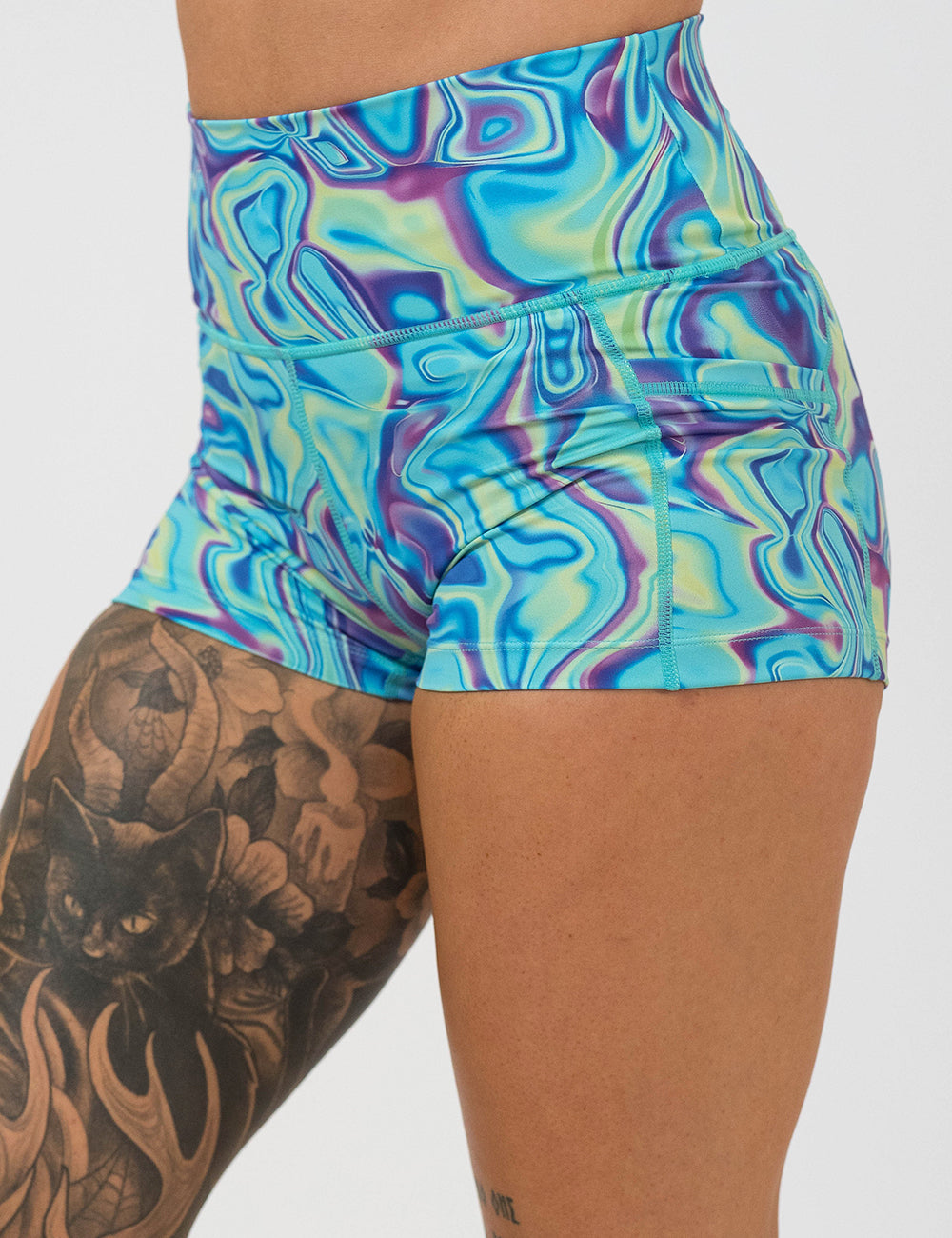 front of the 2.5 inch blue, green, and lavender liquid pattern shorts against a white background