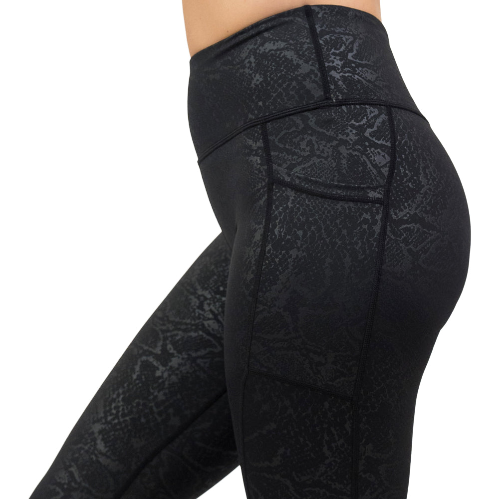 close up of black snake print leggings