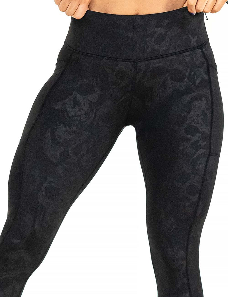 front of the black leggings with a dark grey skull pattern against a white background