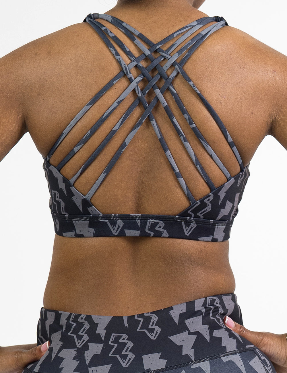 back of the black butterfly back bra with a grey lightning bolt pattern against a white background
