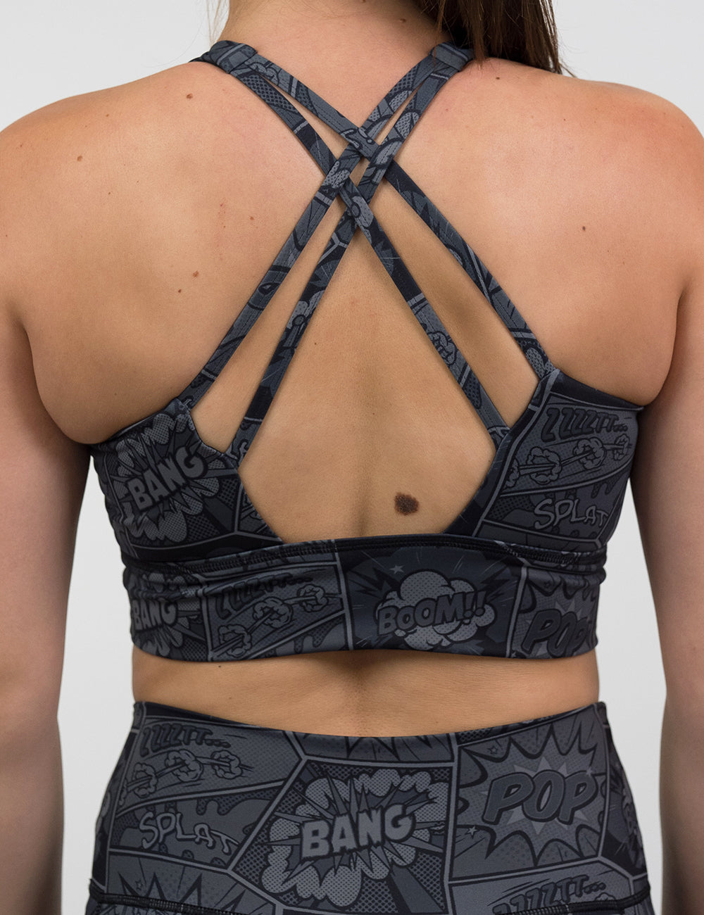 back of the black and grey comic book print long line bra against a white background