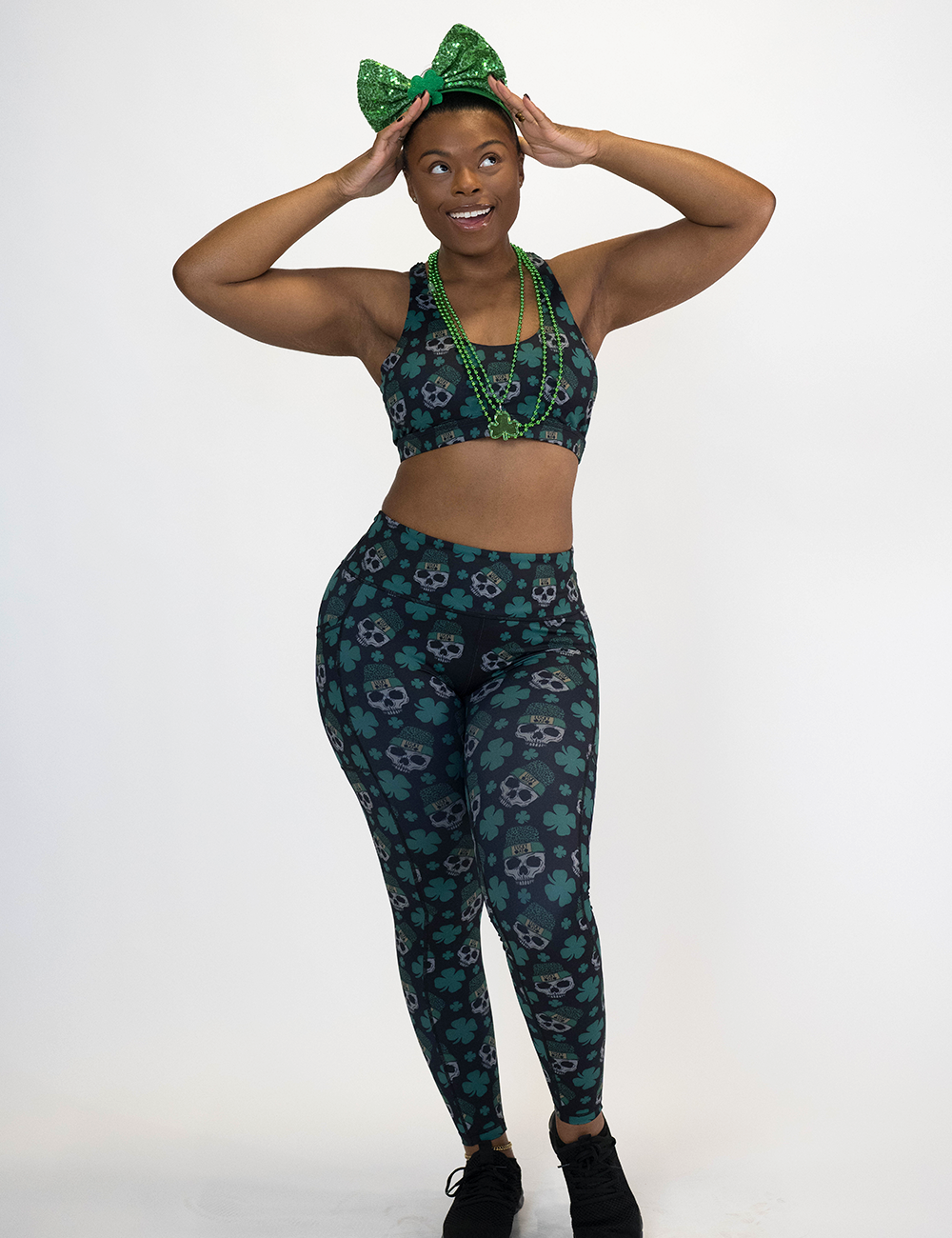 model is wearing the full length shamrock and skull pattern leggings against a white background