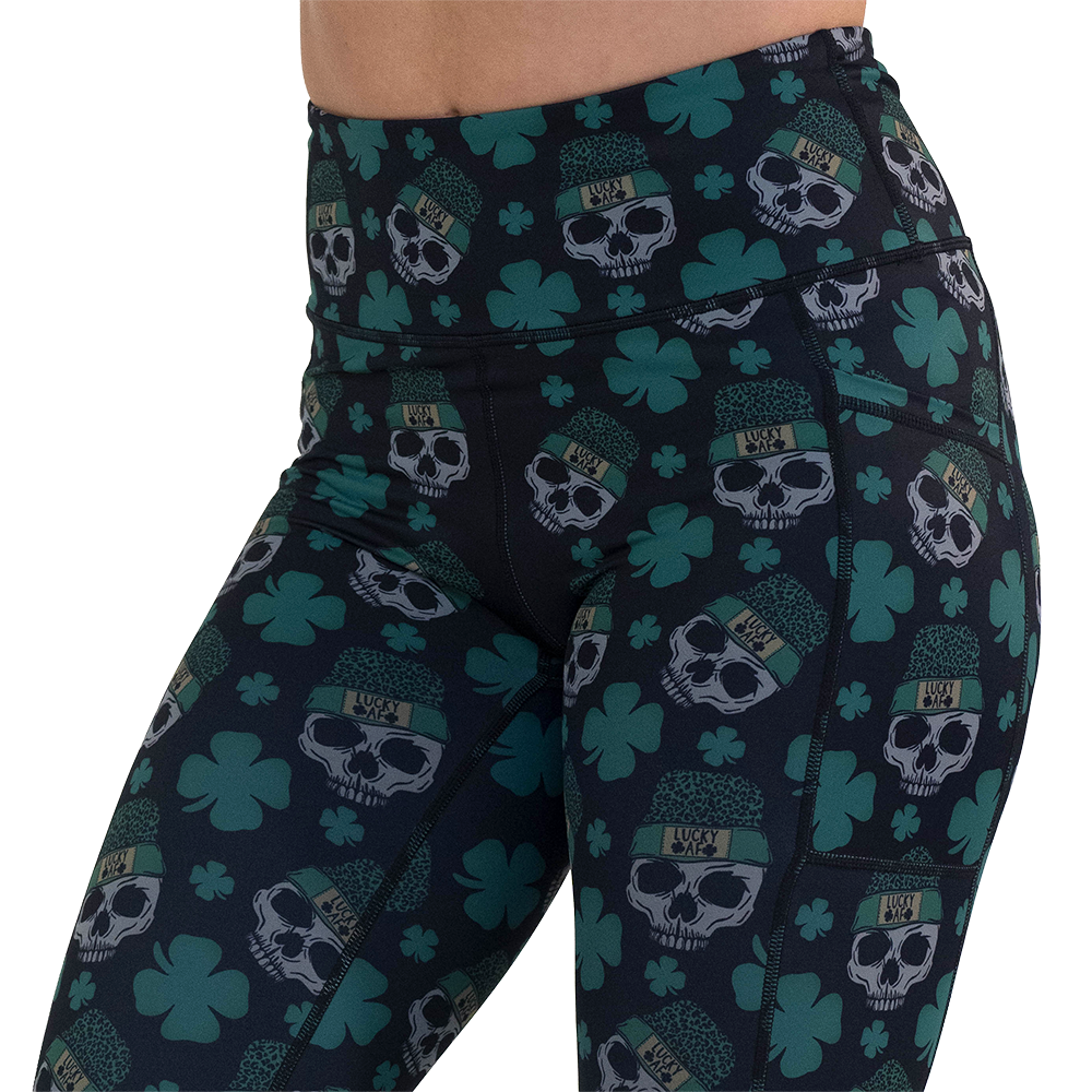 close up of the skull and shamrock print leggings against a white background