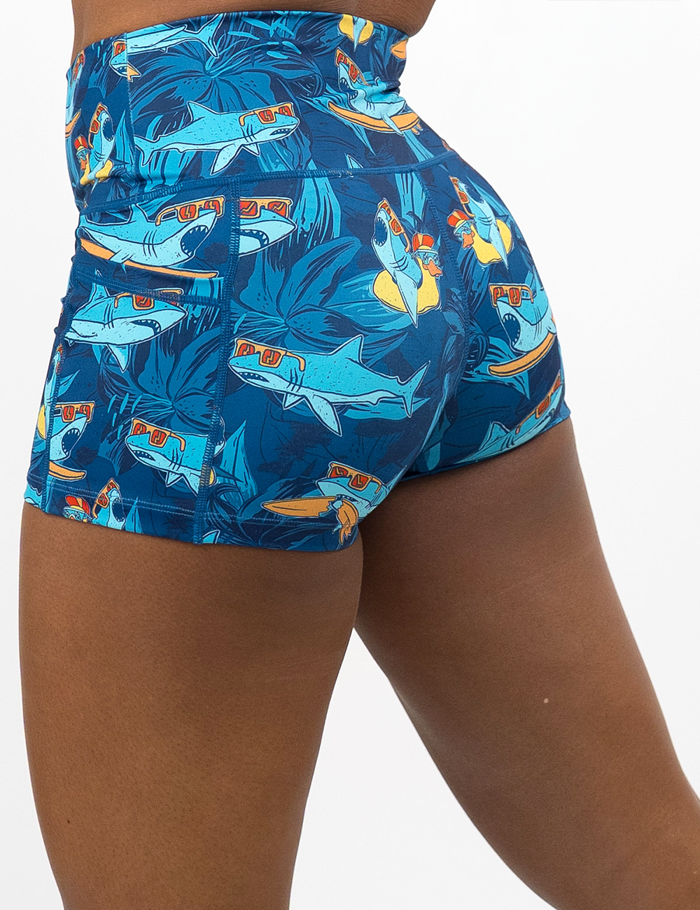 back of the 2.5 inch cartoon sharks surfboarding with sunglasses shorts against a white background