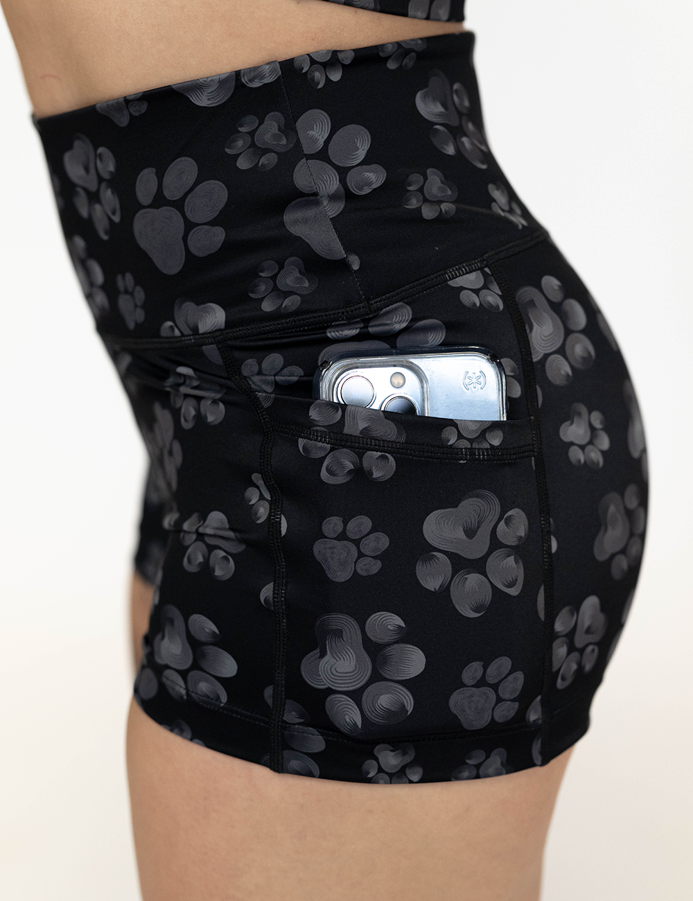 close up of the 2.5 inch grey paws against a black background shorts pocket with a phone in it