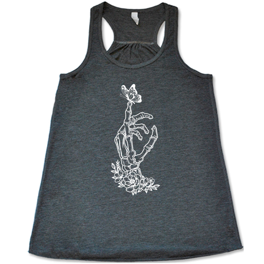 Grey colored flowy tank with a butterfly on a skeletons hand graphic on it