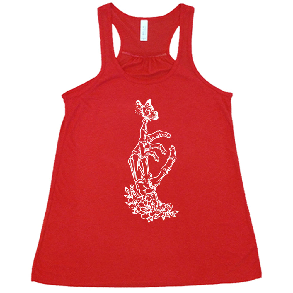 Red colored flowy tank with a butterfly on a skeletons hand graphic on it