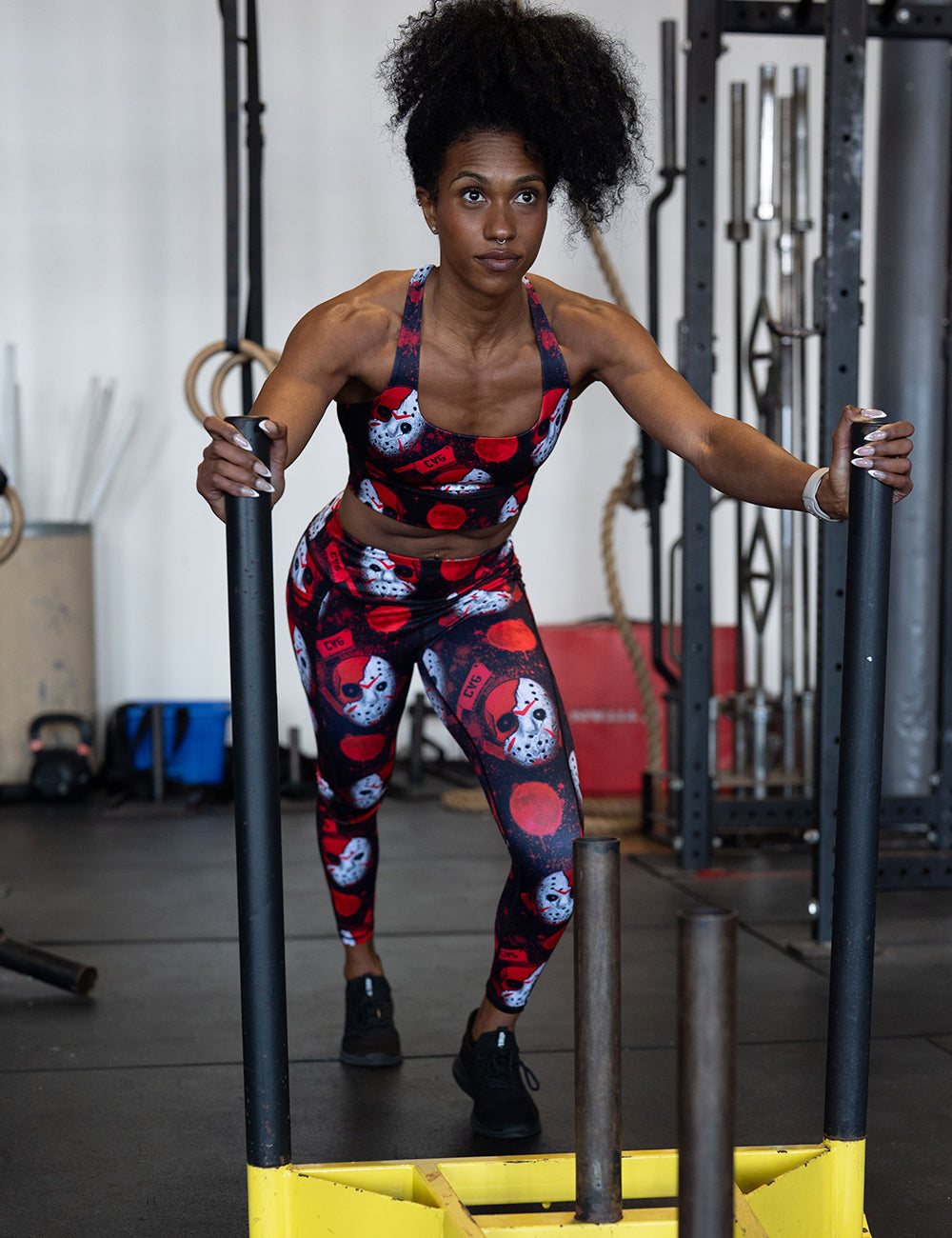 model wearing the bloody hocky mask full length leggings and sports bra working out in the gym