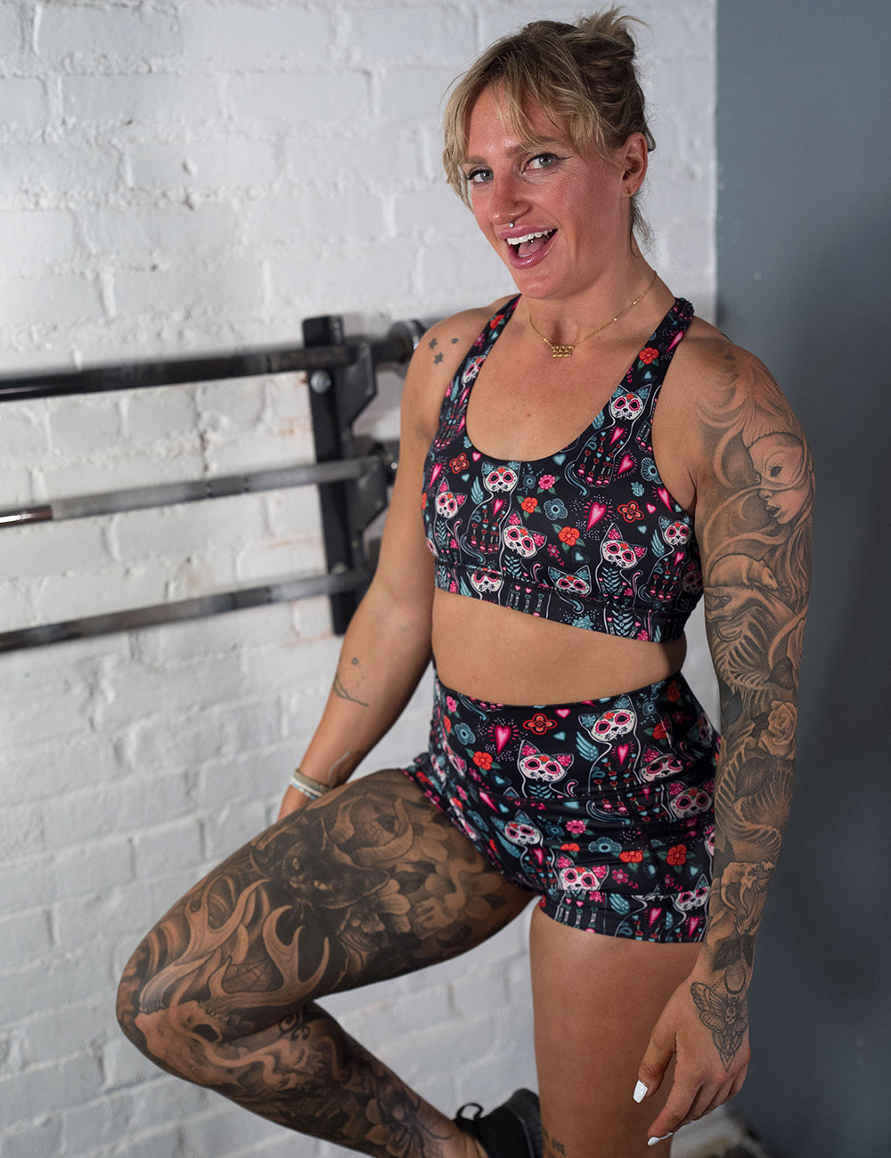 model wearing the 2.5 inch shorts with a colorful cat skull and floral design