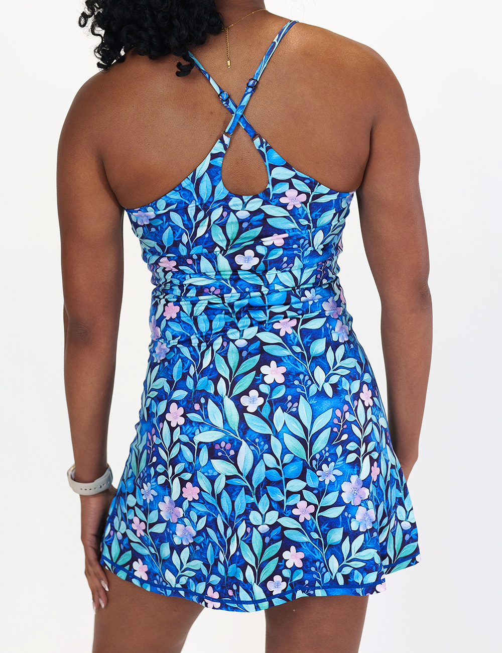 back of the blue flowers and vines limitless dress against a white background