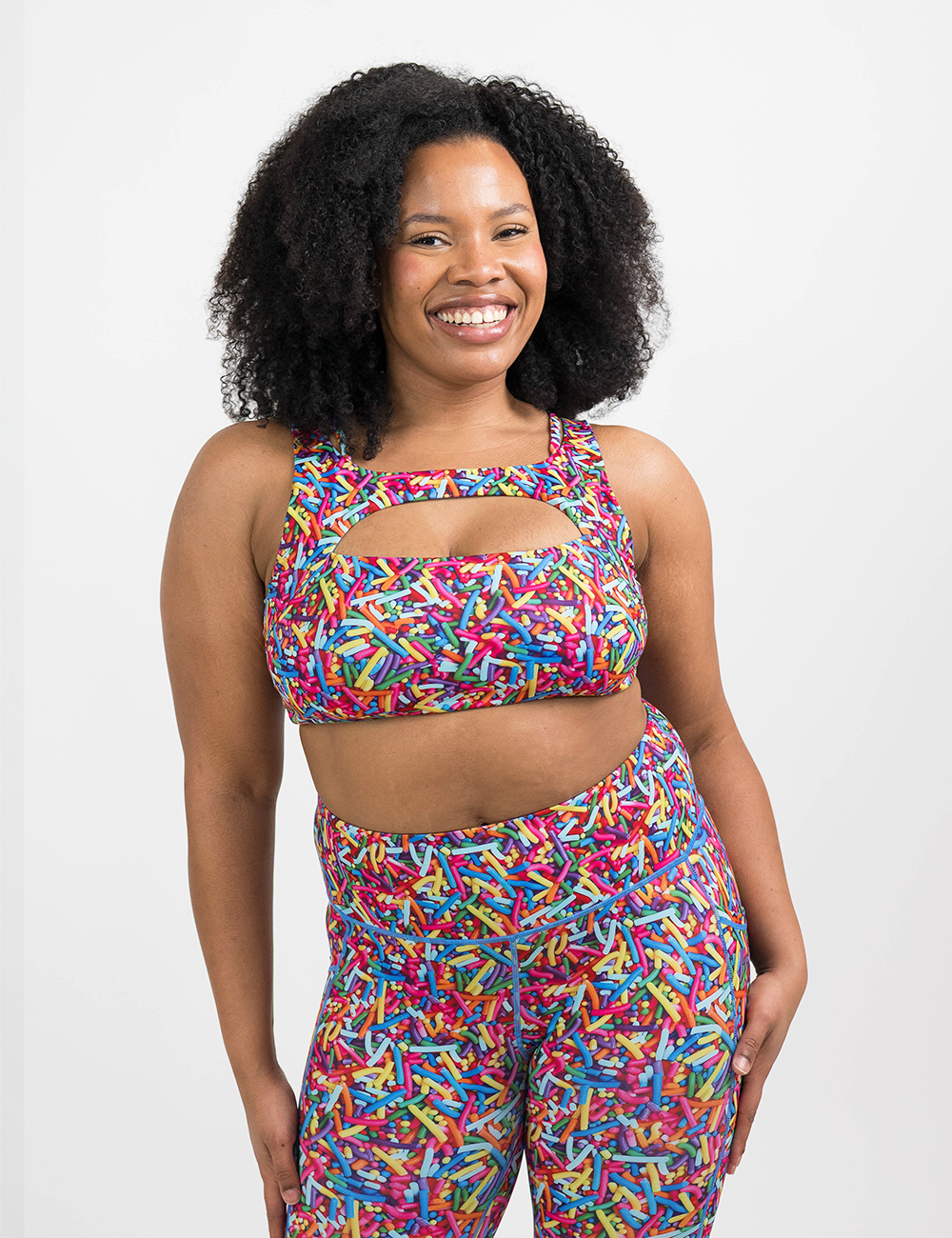 model wearing the rainbow sprinkles vista bra against a white background