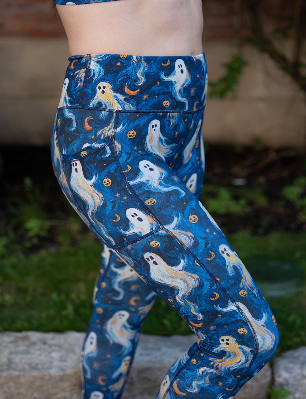model wearing the starry night ghosts against a blue background pattern leggings