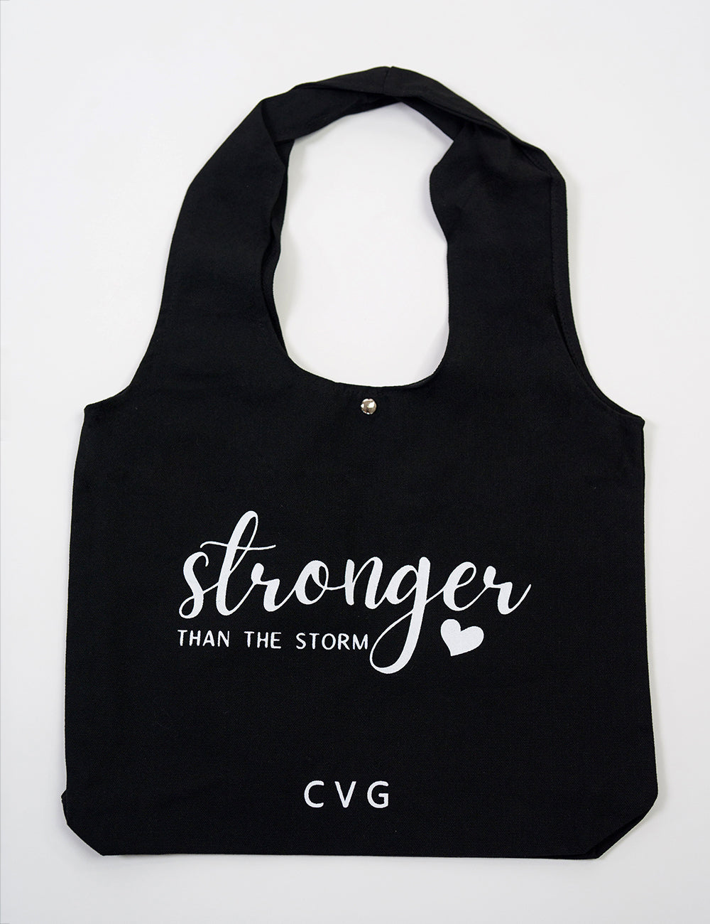 Black tote bag with the CVG logo and the large words "stronger than the storm" on it