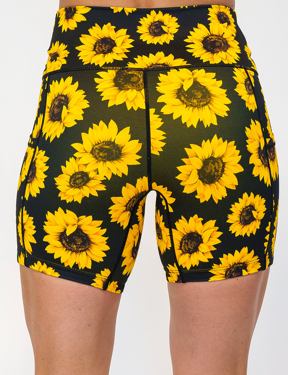 back of the 5 inch yellow flower shorts against a white background