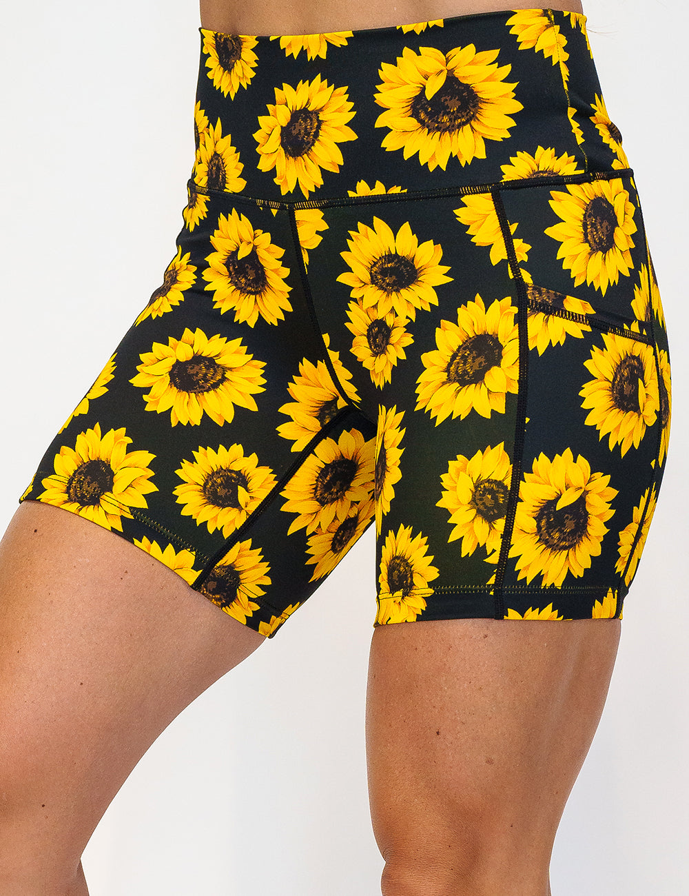 front of the 5 inch yellow flower shorts against a white background