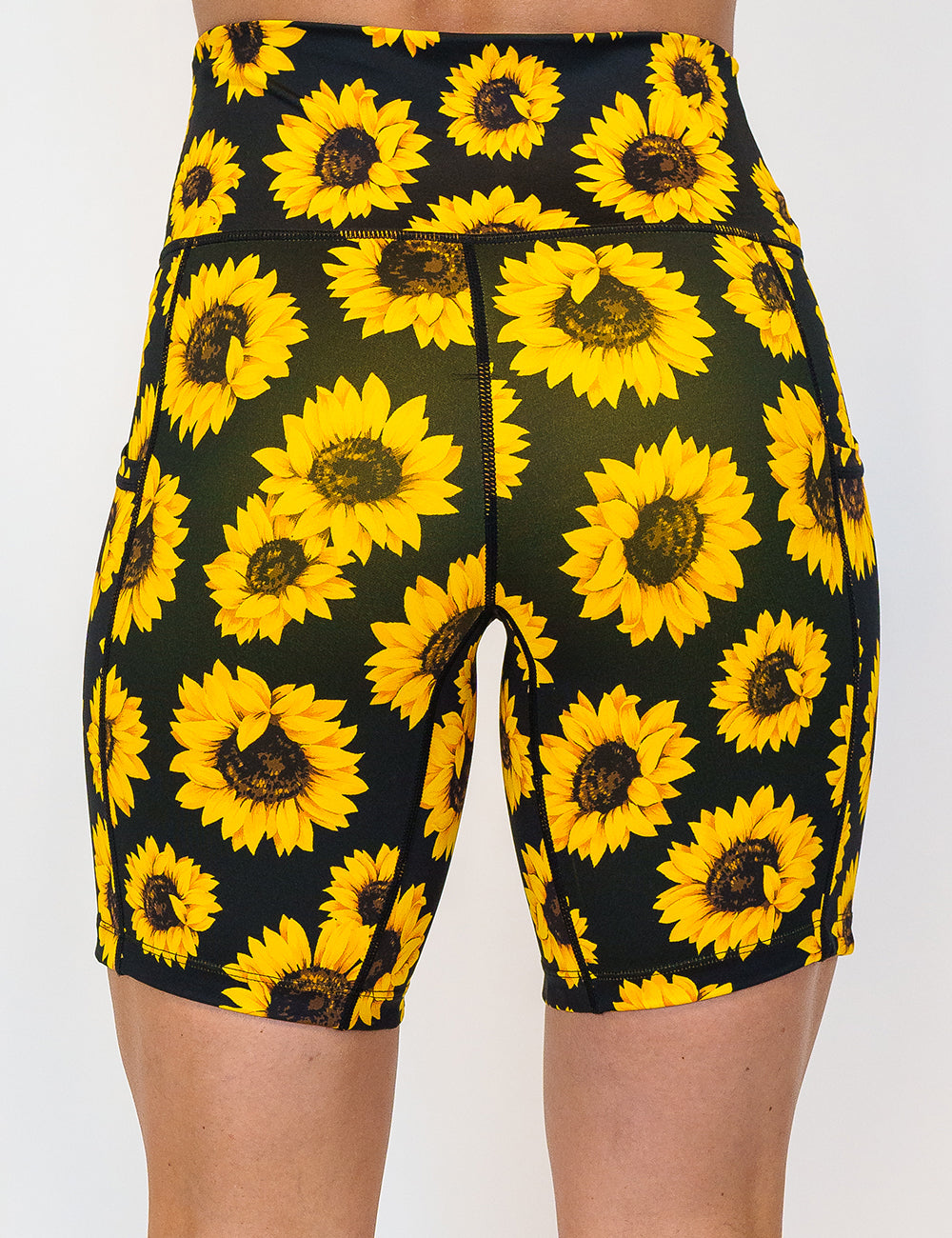 back of the 7 inch yellow flower shorts against a white background