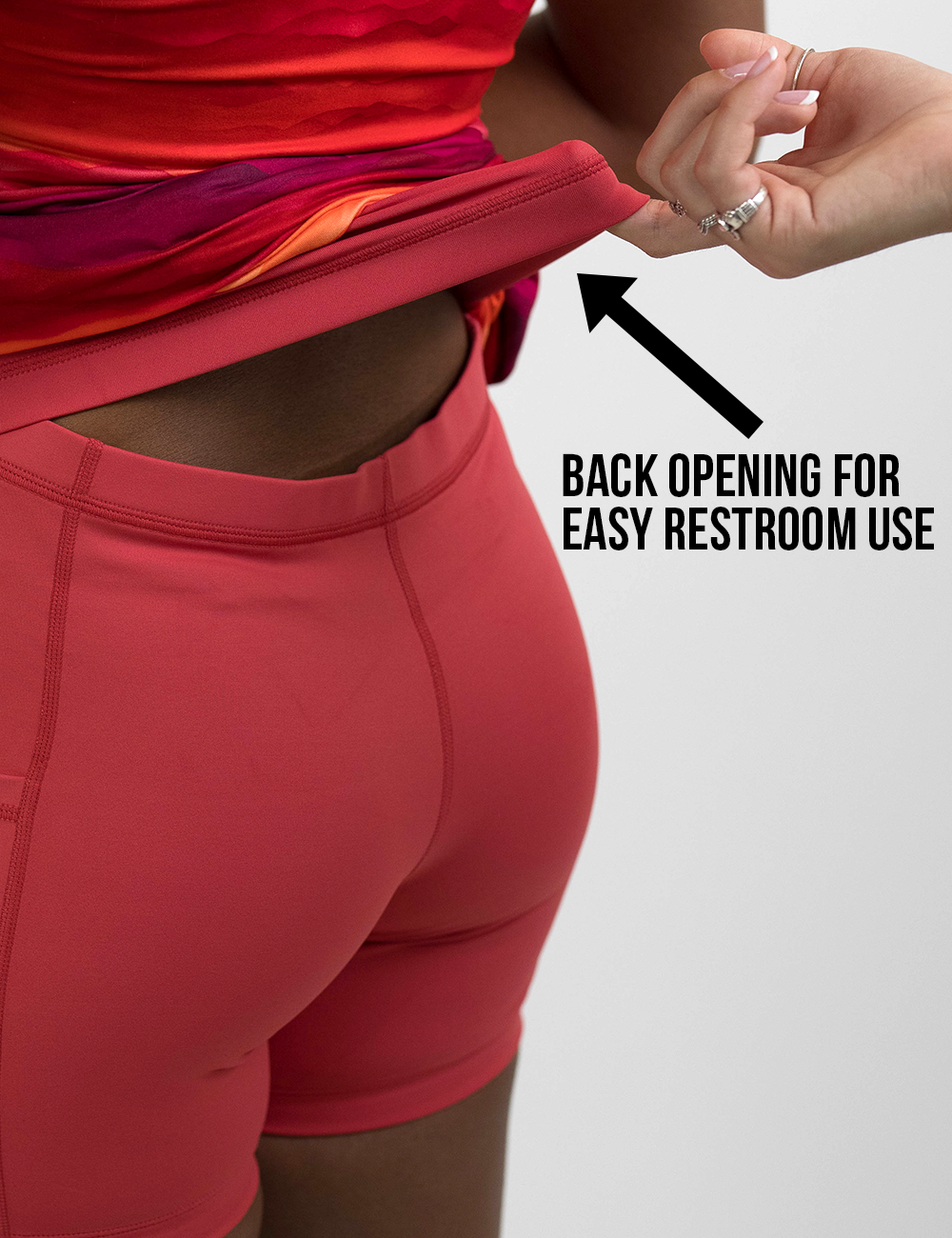 back of the sunrise dress lifted to show the shorts underneath for easy restroom use against a white background