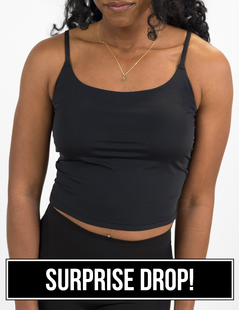 front of the solid black cami top against a white background surprise drop