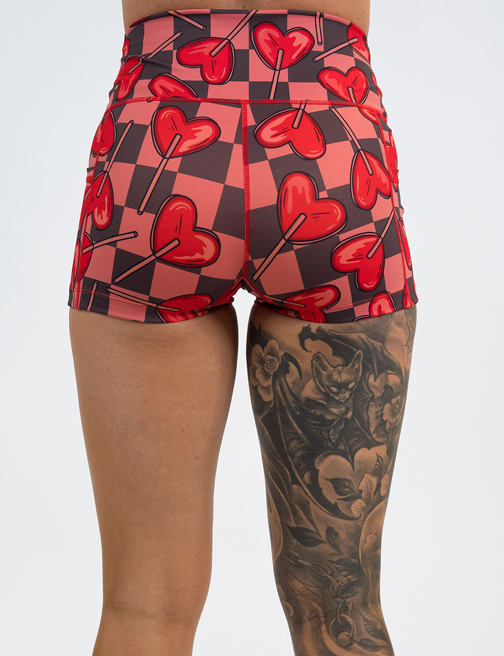 back of the 2.5 inch heart lollypops on a checker board pattern shorts against a white background