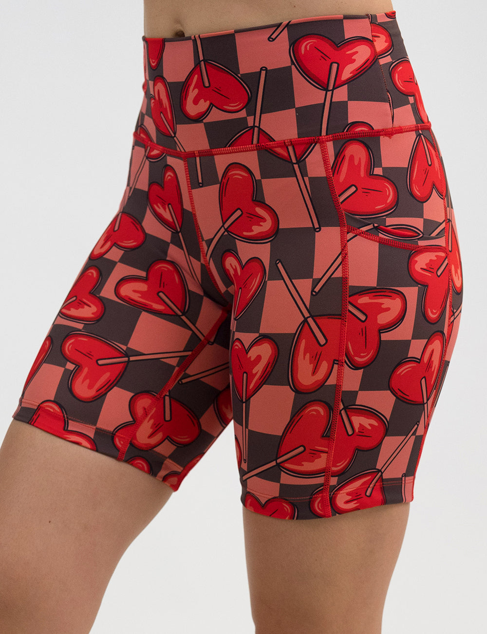 front of the 7 inch heart lollypops on a checker board pattern shorts against a white background