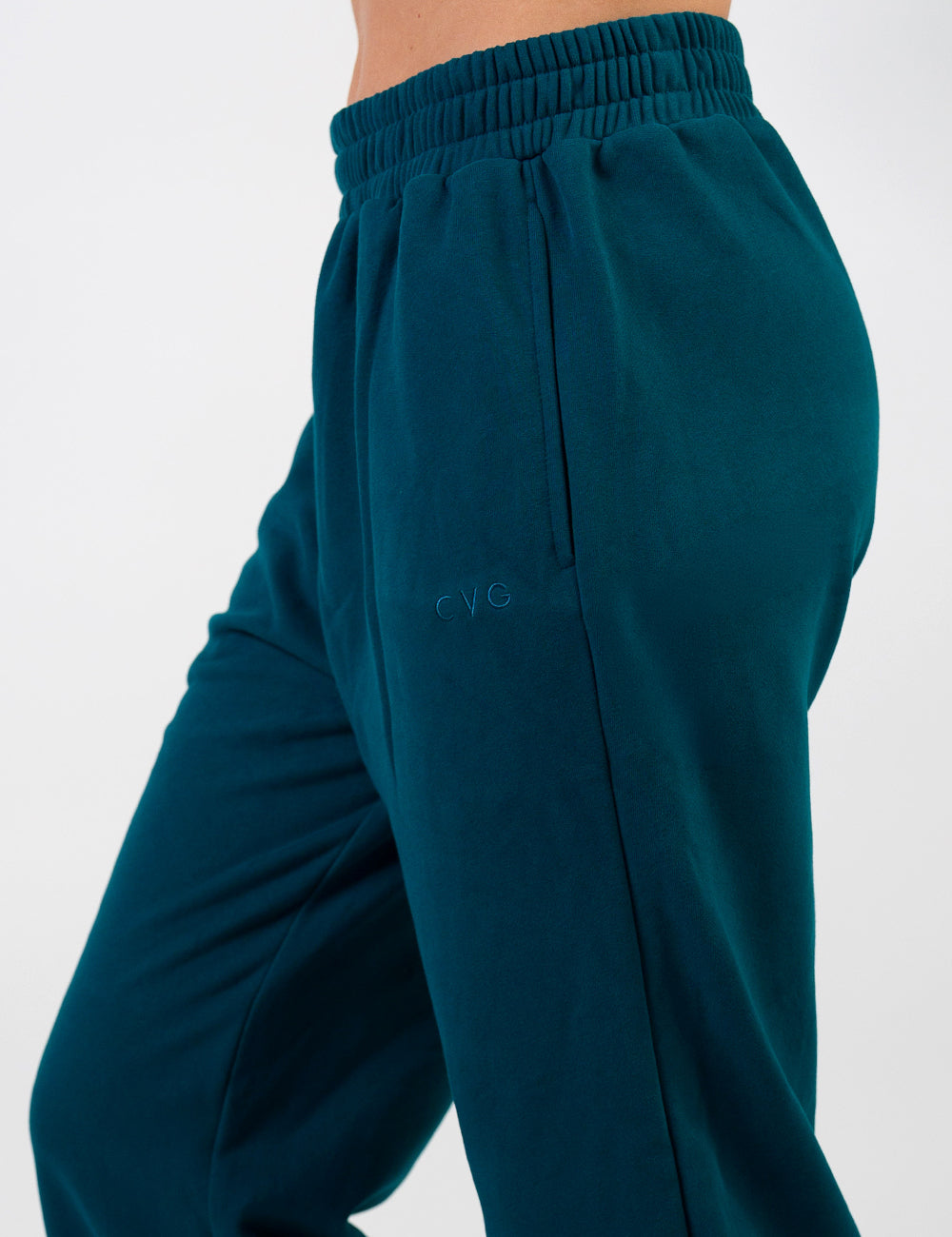 front of the dark blue sweatpants with a subtle CVG logo against a white background