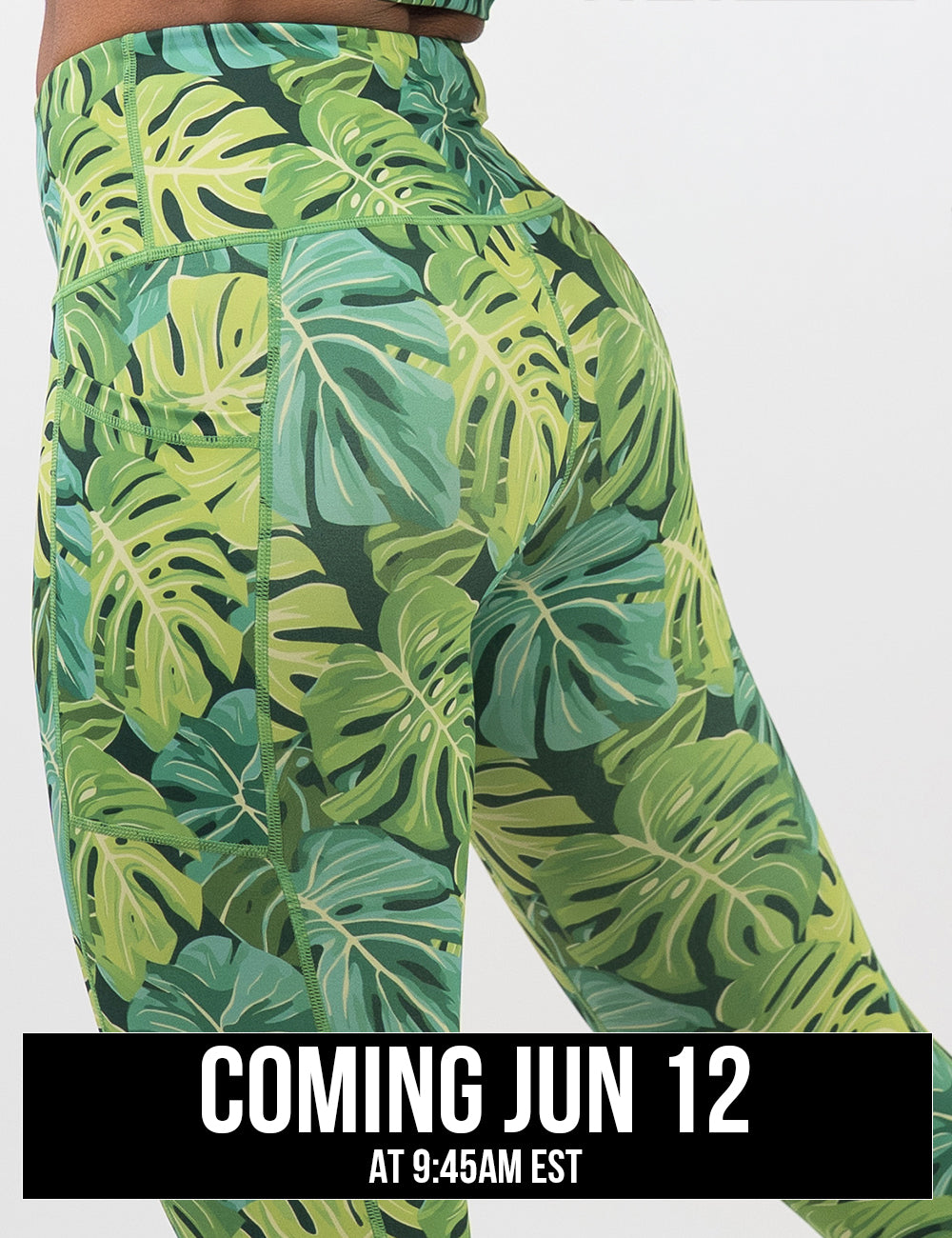 back of the green tropical leaves leggings against a white background, coming june 12th