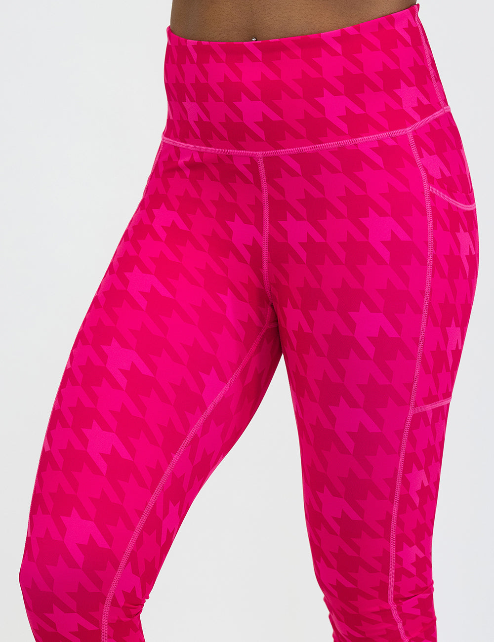 front of the pink houndstooth leggings against a white background