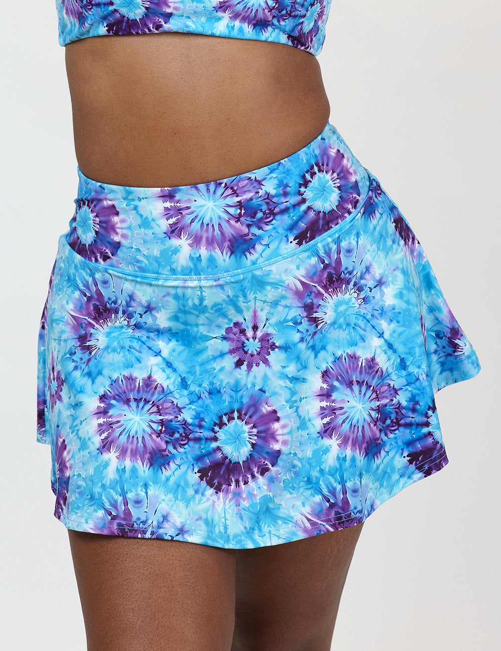 front of the blue and purple tie dye skirt against a white background