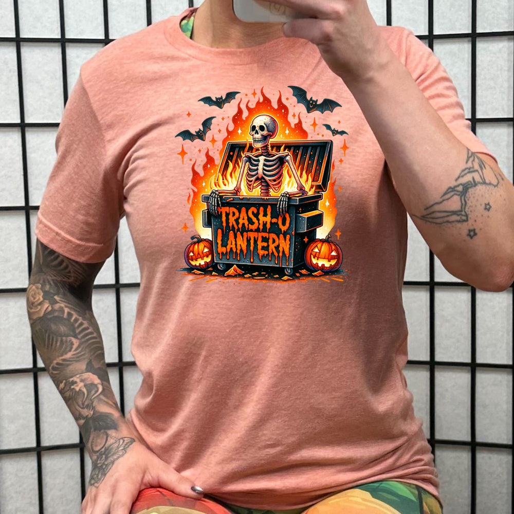 peach shirt with a skeleton graphic and the quote "trash-o lantern" on it