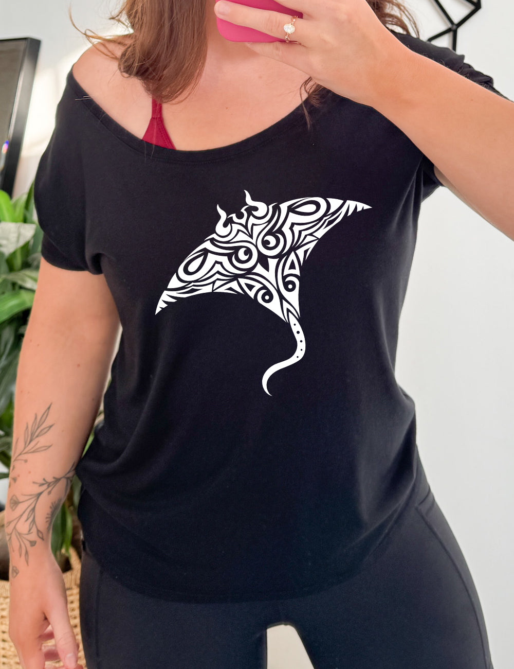black slouchy tee with the graphic of a manta ray in tribal design