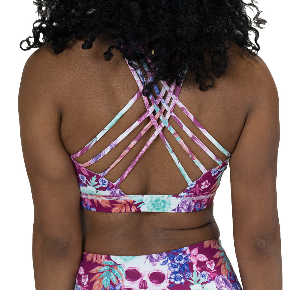 back of the skull and flower patterned sports bra