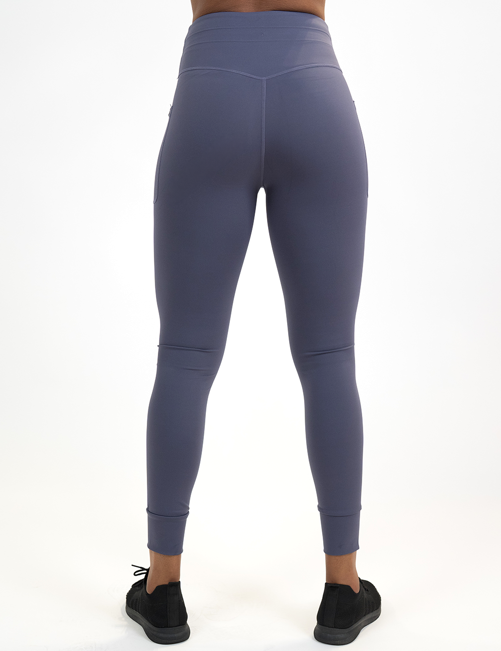 back of the omni full length purple twilight leggings against a white background