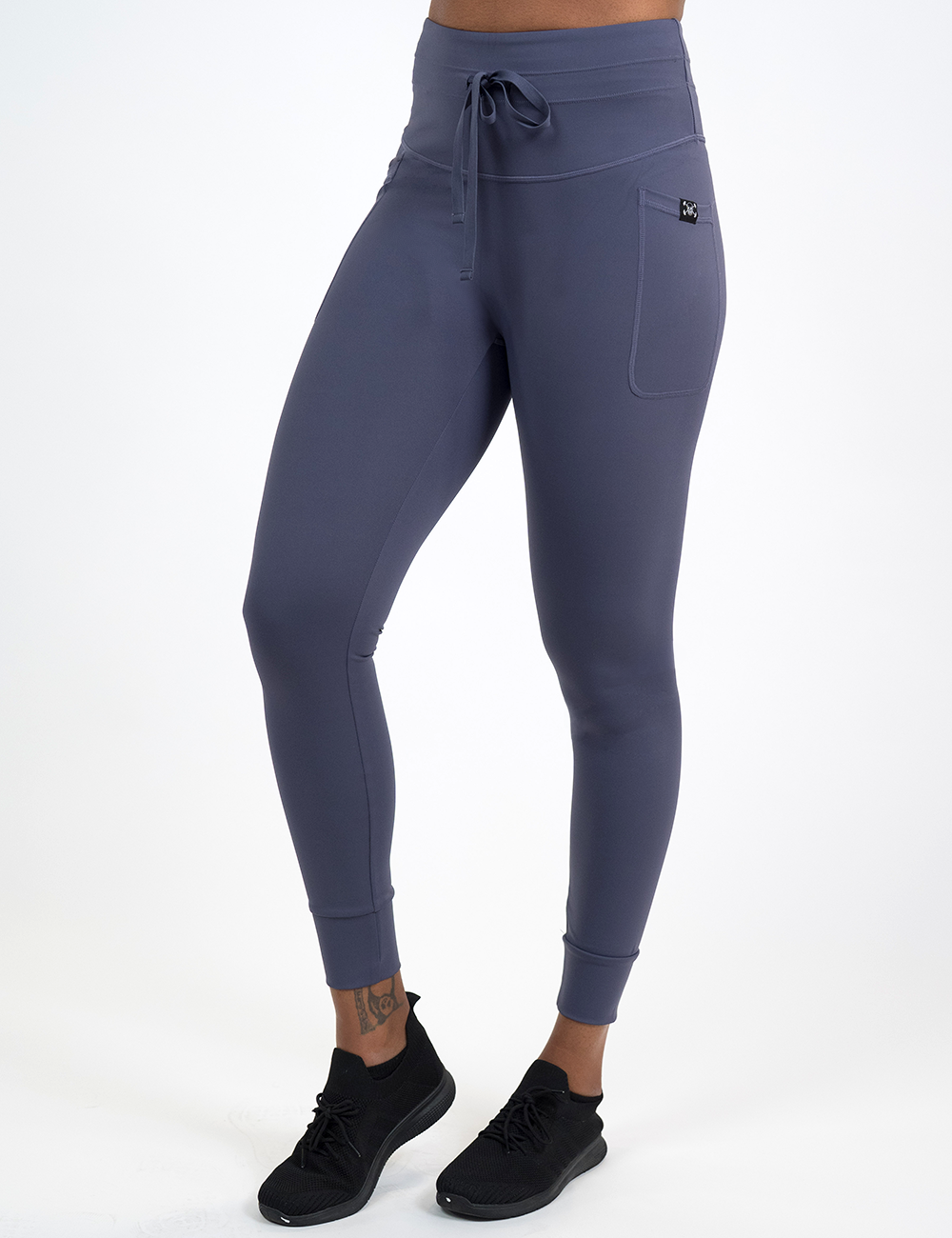 model wearing the full length omni twilight purple drawstring leggings facing the front against a white background