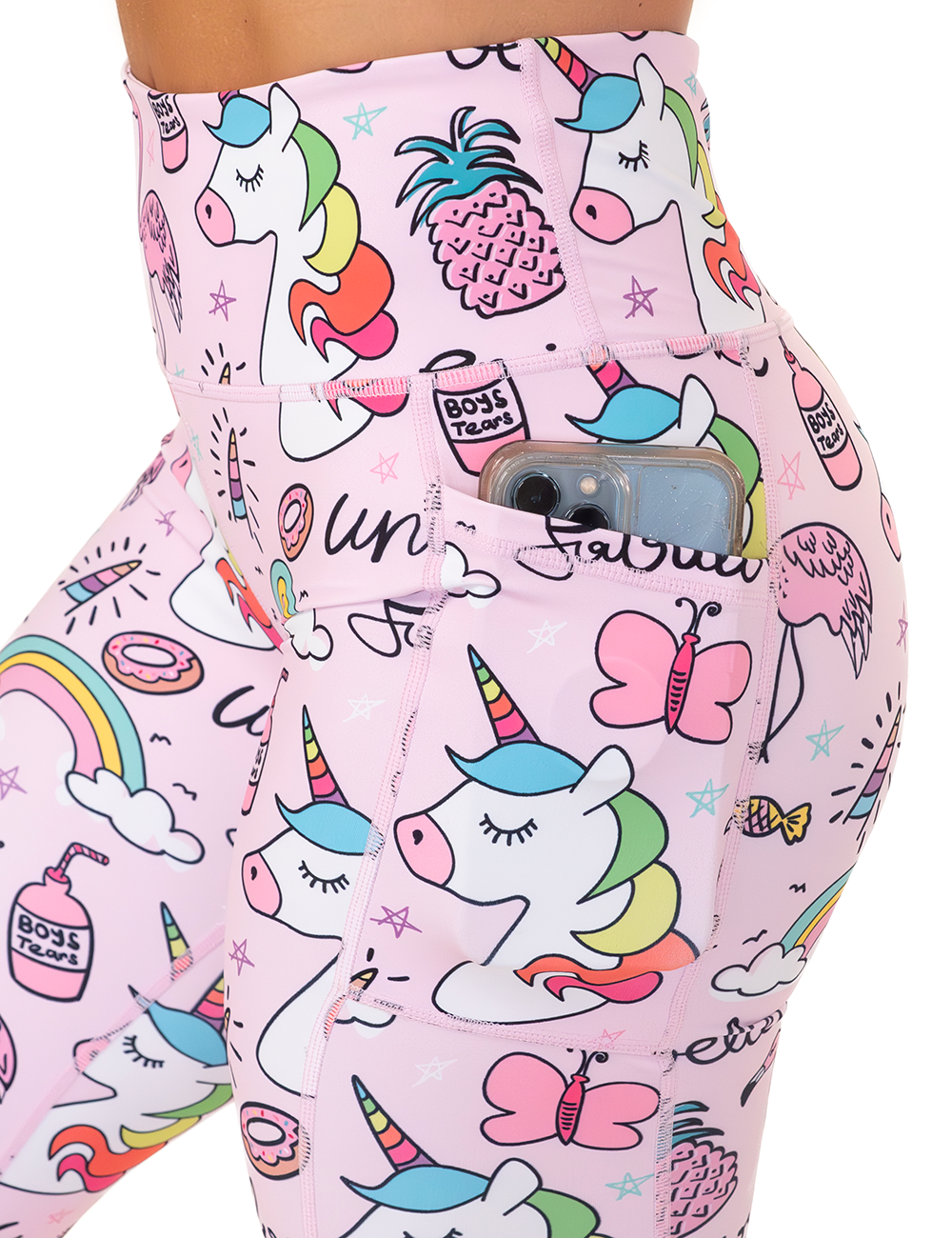 close up of the the pink unicorn and colorful icons print leggings with a phone in its pocket