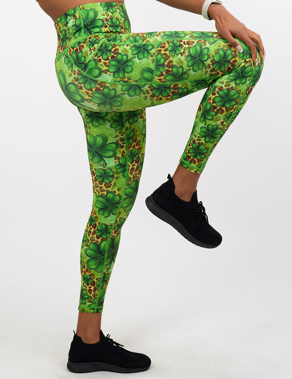 model wearing the clover pattern against a cheetah print and green background full length leggings against a white background