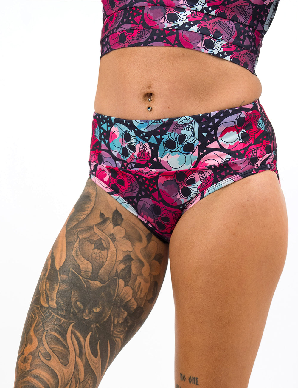 front of the pink and blue skulls pattern swim suit bottom against a white background