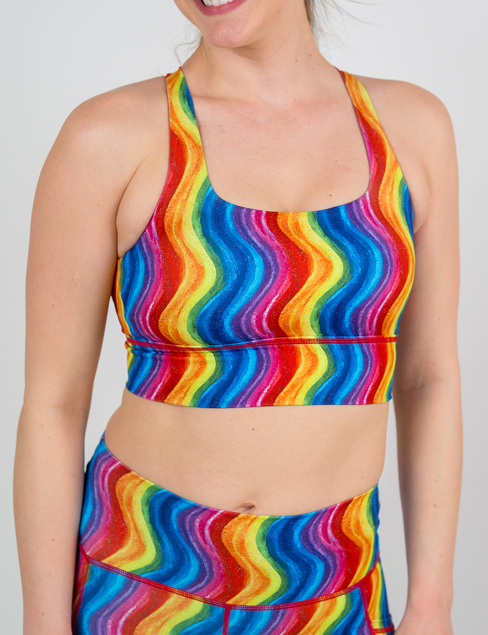 front of the rainbow waves longline bra against a white background