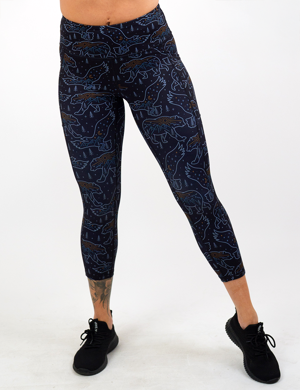 bird and bear outlines against a dark background capri leggings facing the front against a white background