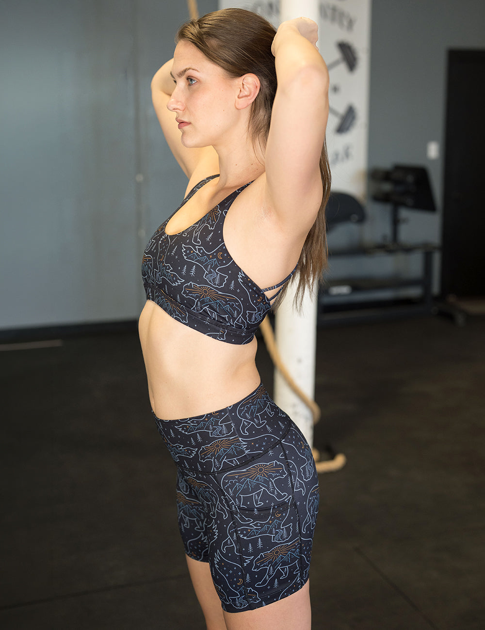model wearing the 7 inch close up of the bird and bear outlines against a dark background shorts in the gym