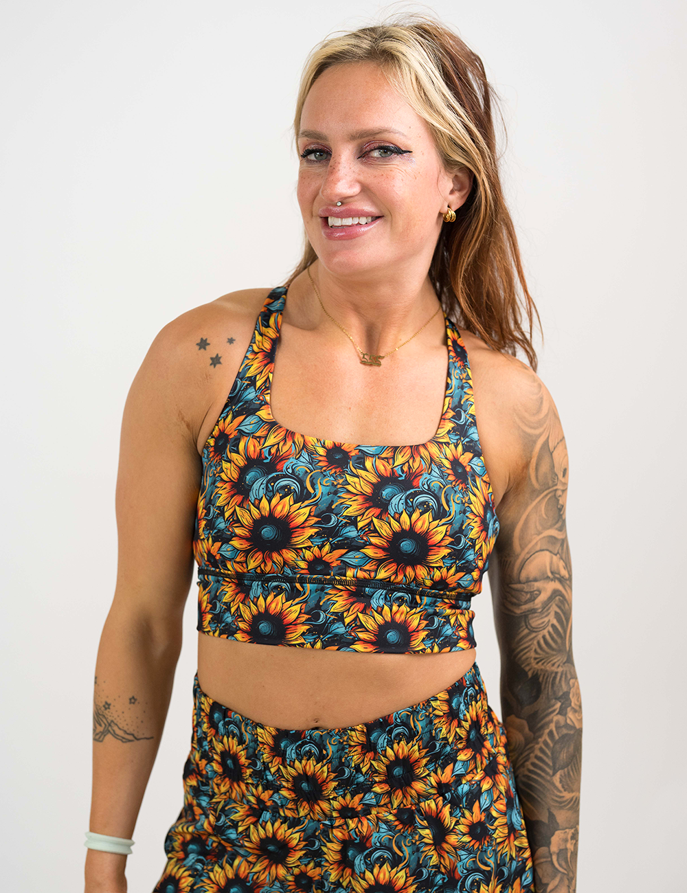 model wearing the sunflower print longline bra against a white background