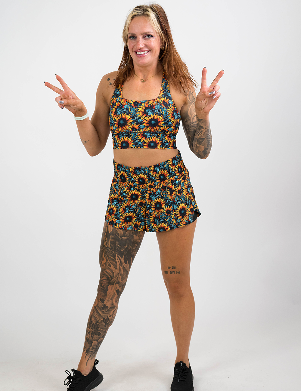 model wearing the sunflower print bra and shorts against a white background