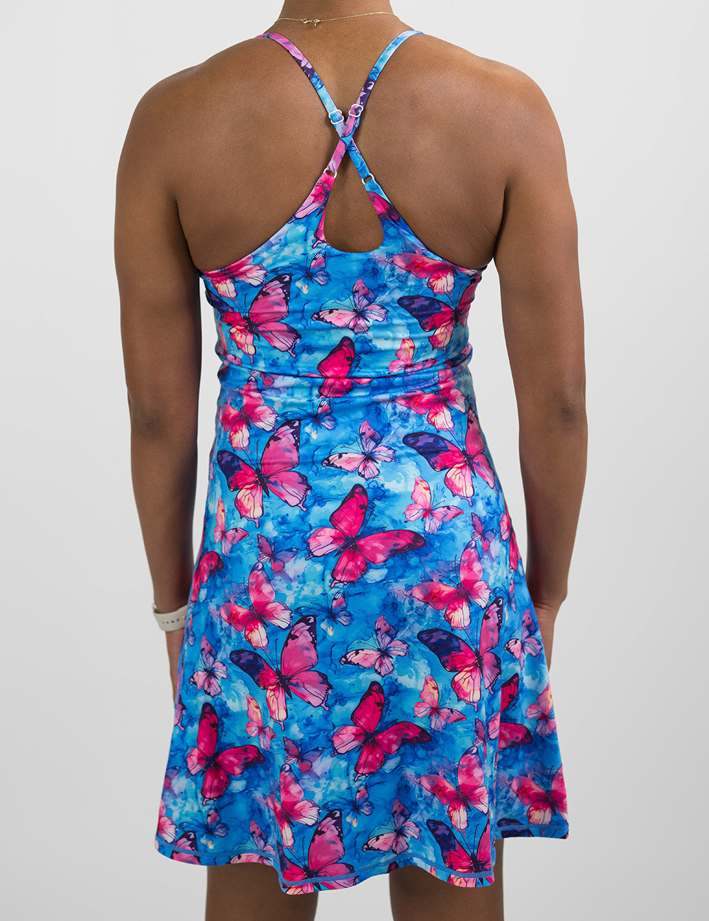 back of the longer length red butterflies against a blue background dress against a white background