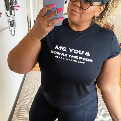 model wearing the black me you & winnie the pooh cropped tee