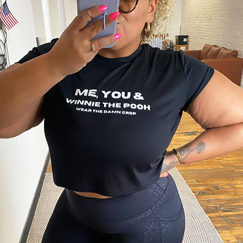 model wearing the black me you & winnie the pooh cropped tee