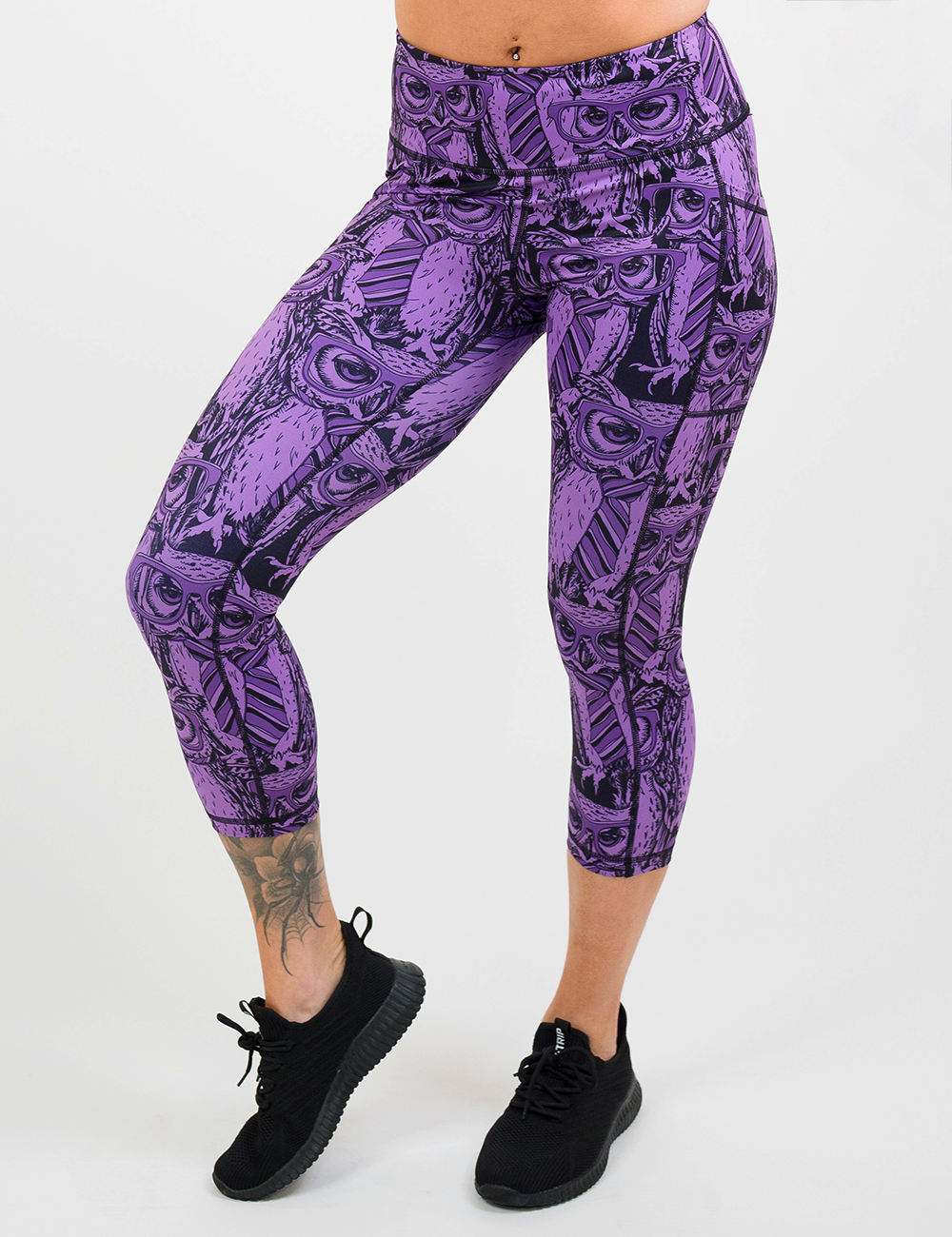 purple owl wearing glasses and a tie print capri leggings facing the front against a white background