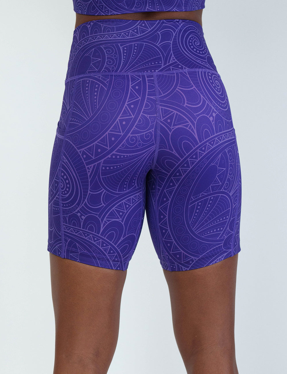 back of the 7 inch purple with a white swirl pattern shorts against a white background