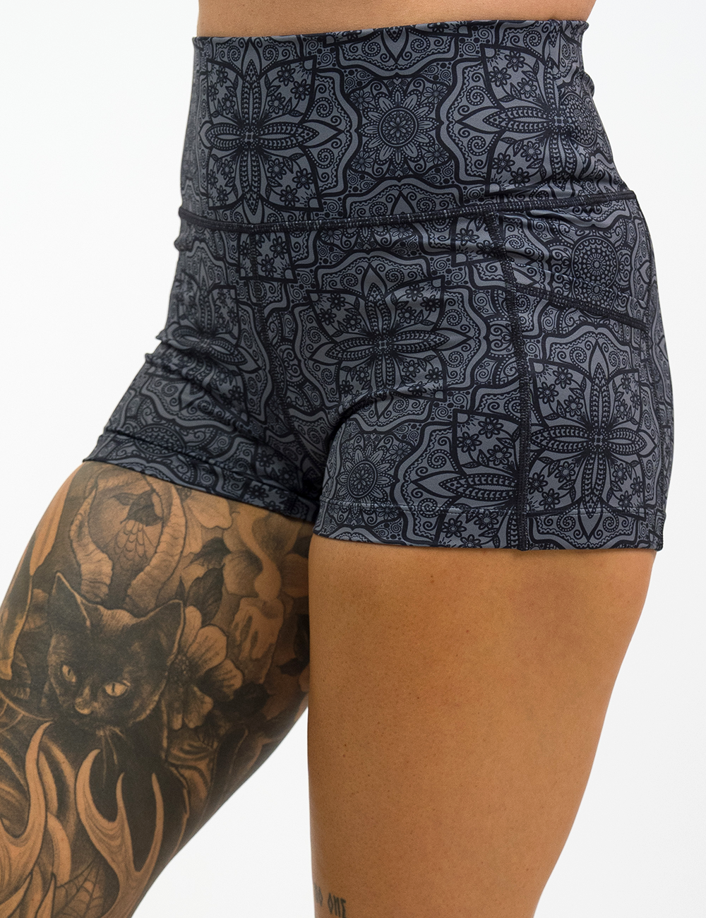 close up of black mandala pattern 2.5 inch shorts against a white background