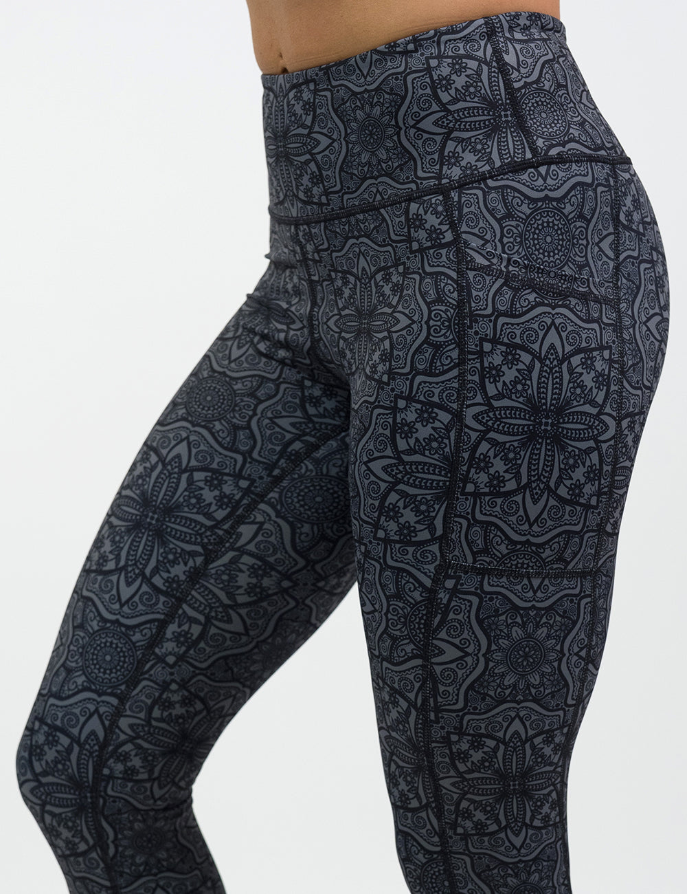 close up of black mandala pattern leggings against a white background