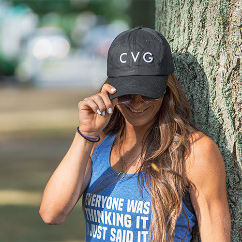 Photo of a model wearing a black snapback hat that has the CVG logo on the front